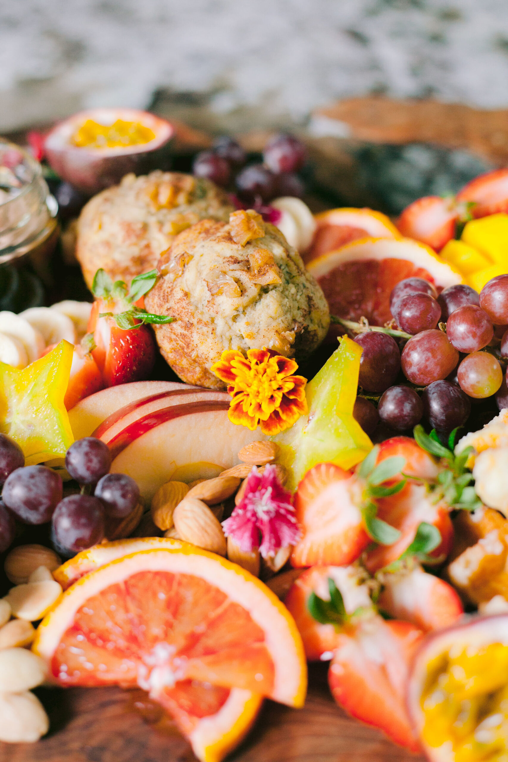 Assortment of muffins, grapes, strawberries and oranges