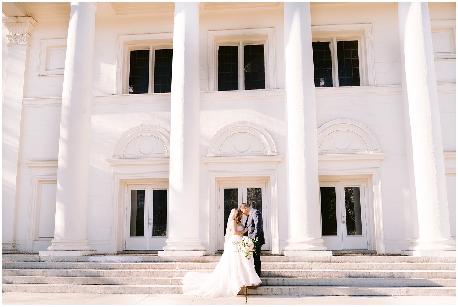 Wedding couple in front of white church