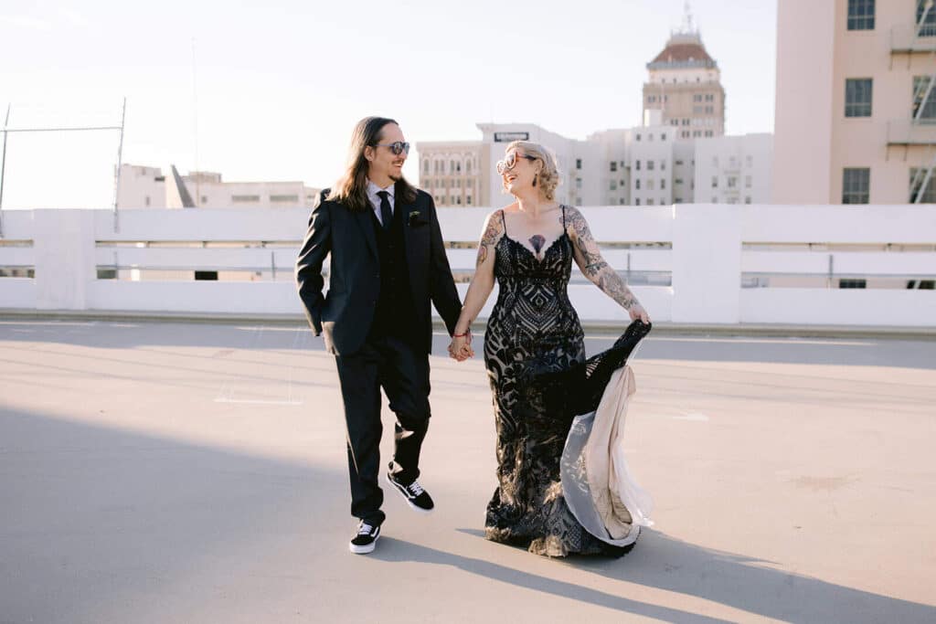 Romantic dip on Fresno rooftop after courthouse wedding Groom dipping bride on rooftop with Fresno skyline in the background after courthouse wedding