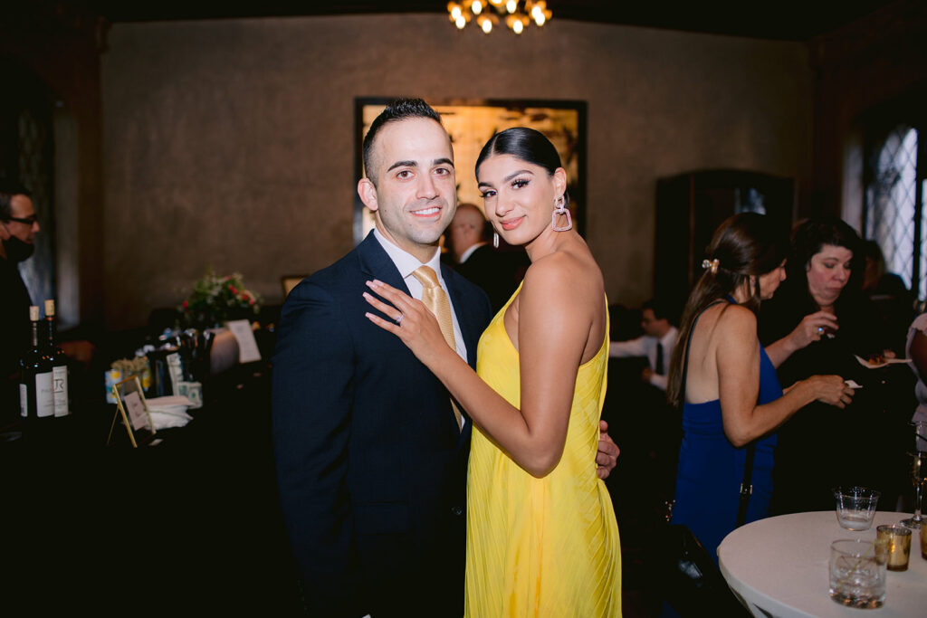 Couple dressed in formal attire pose for a portrait during the reception inside the Berkley City Club wedding venue, captured by Michelle Gunn Photo at a vibrant lesbian wedding.