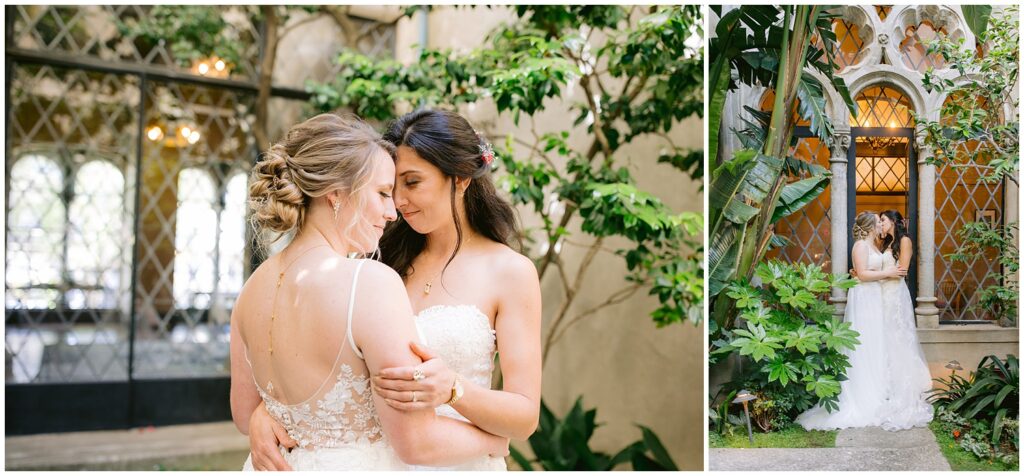 Two brides stand close together in the garden courtyard of a Berkley City Club wedding venue, framed by arched windows and greenery during their lesbian wedding photographed by Michelle Gunn Photo.