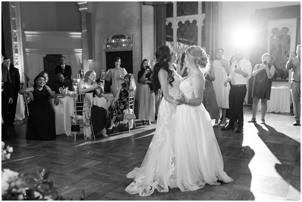 Two brides share their first dance surrounded by guests at their Berkley City Club wedding reception, photographed by Michelle Gunn Photo during a romantic lesbian wedding.