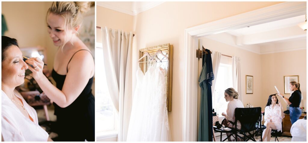 Makeup artist applies finishing touches as one bride smiles, while the other bride gets ready nearby in a softly lit room before their Berkley City Club wedding, photographed by Michelle Gunn Photo at a lesbian wedding.