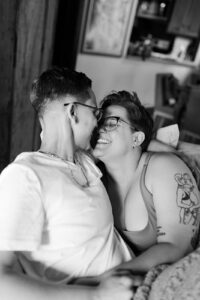 Cozy living room scene of a couple snuggled together before their Fresno wedding