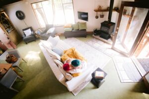 Aerial view of LGBTQ+ couple cuddling on a couch at their Fresno wedding Airbnb