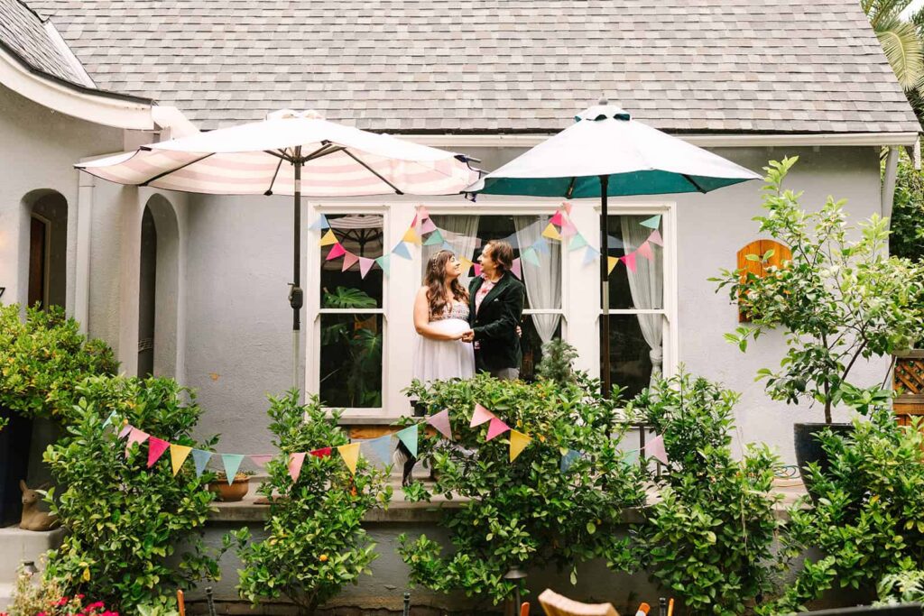 Couple relaxing on their front porch during their intimate Porchfest Fresno wedding in the Tower District.