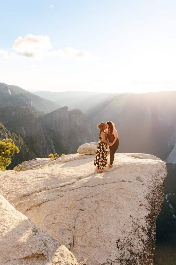 Queer couple watching sunset at Taft Point Yosemite after proposal