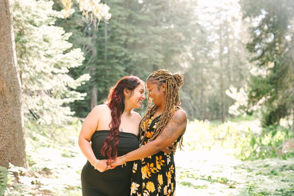 LGBTQ+ couple hiking to Taft Point in Yosemite for a surprise proposal session
