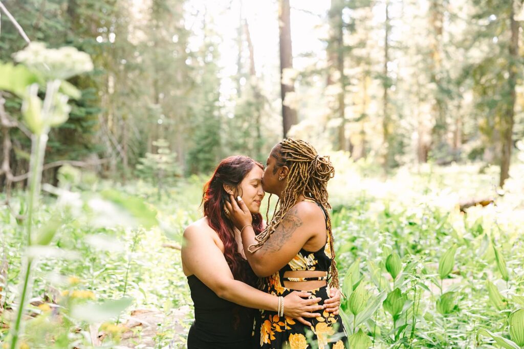 LGBTQ+ couple hiking to Taft Point in Yosemite for a surprise proposal session